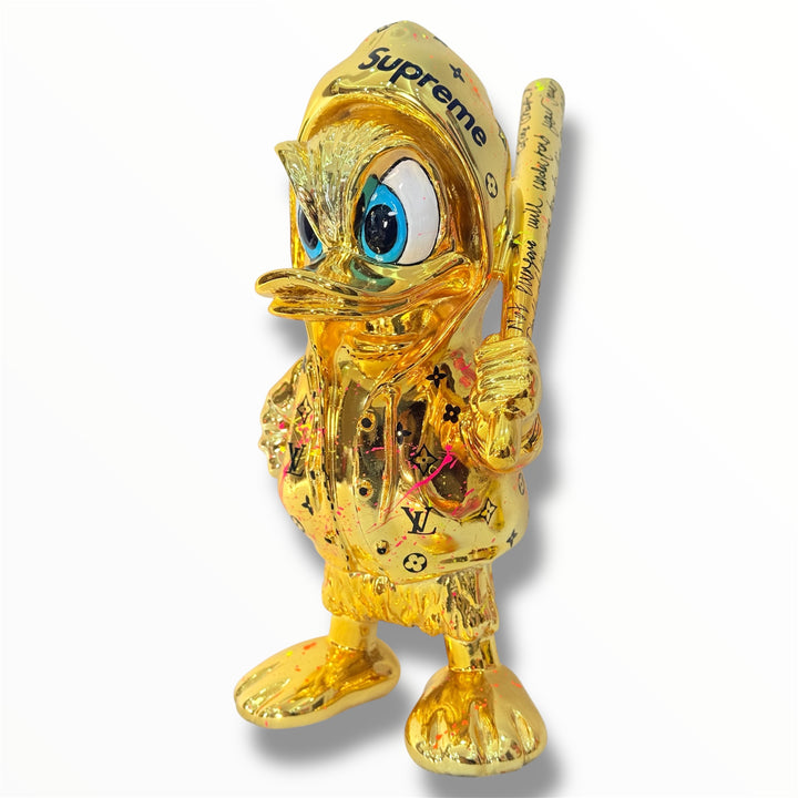 gold chrome duck sculpture with supreme and lv graffiti design