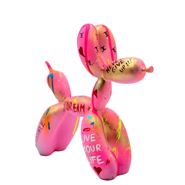 Pink balloon dog sculpture with motivational text on a light gray background